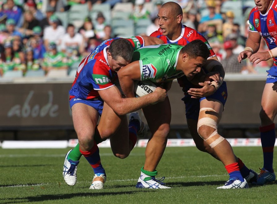 Photo by Colin Whelan copyright © nrlphotos.com :    Josh Papalii wrapped up by Houston and Jeremy Smith    NRL Rugby League, Telstra Cup Round 6 Canberra Raiders v Newcastle Knights at Canberra, Saturday April 12th 2014.
