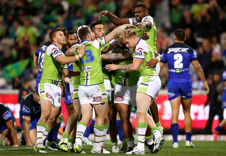 Blake Austin of the Raiders celebrates with team mates after scoring during the round eleven NRL match between the Canberra Raiders and the Bulldogs at GIO Stadium on May 24, 2015 in Canberra, Australia.